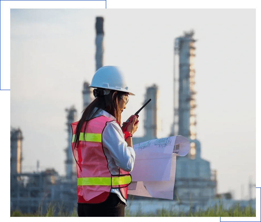 Person using radio at refinery site